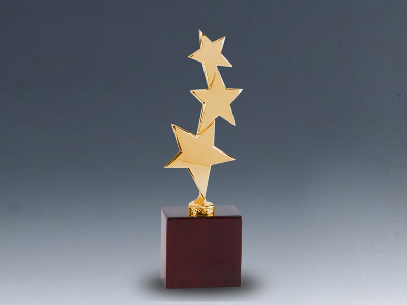 Three gold stars on wood base